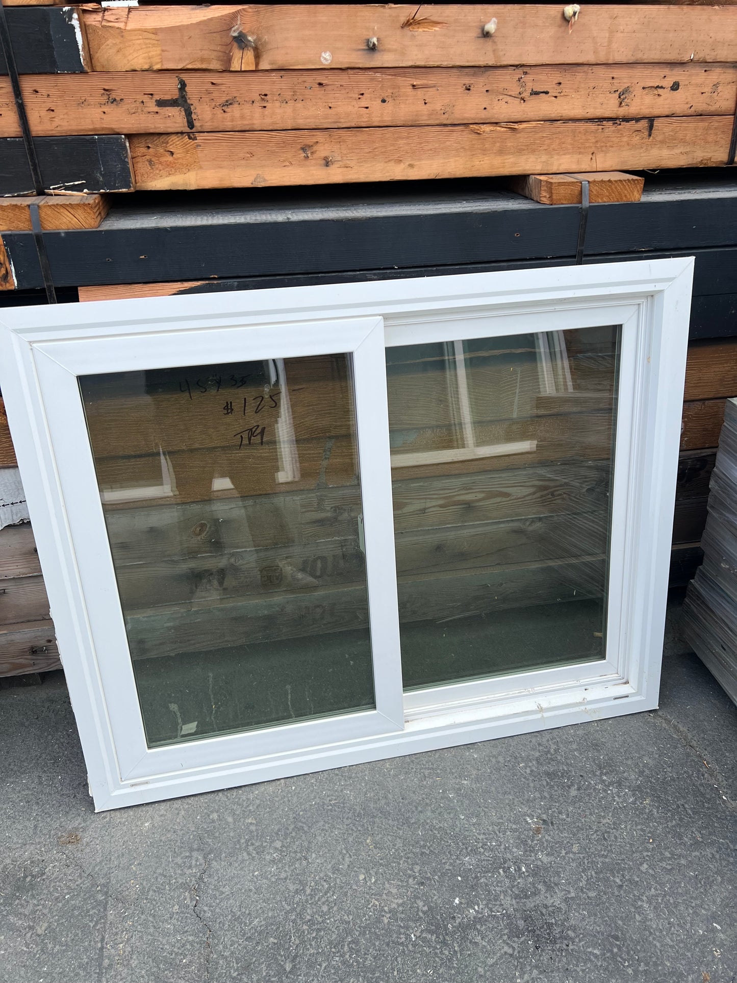White vinyl sliding window side angle