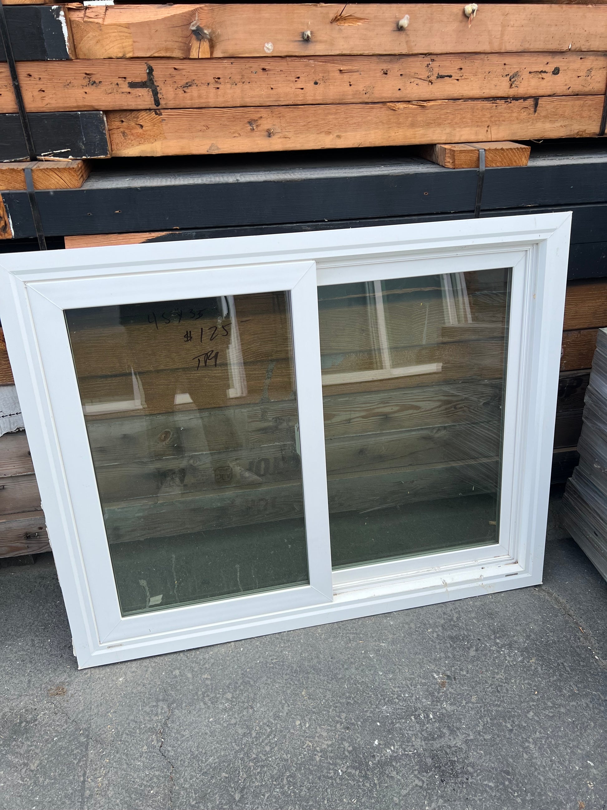 White vinyl sliding window side angle