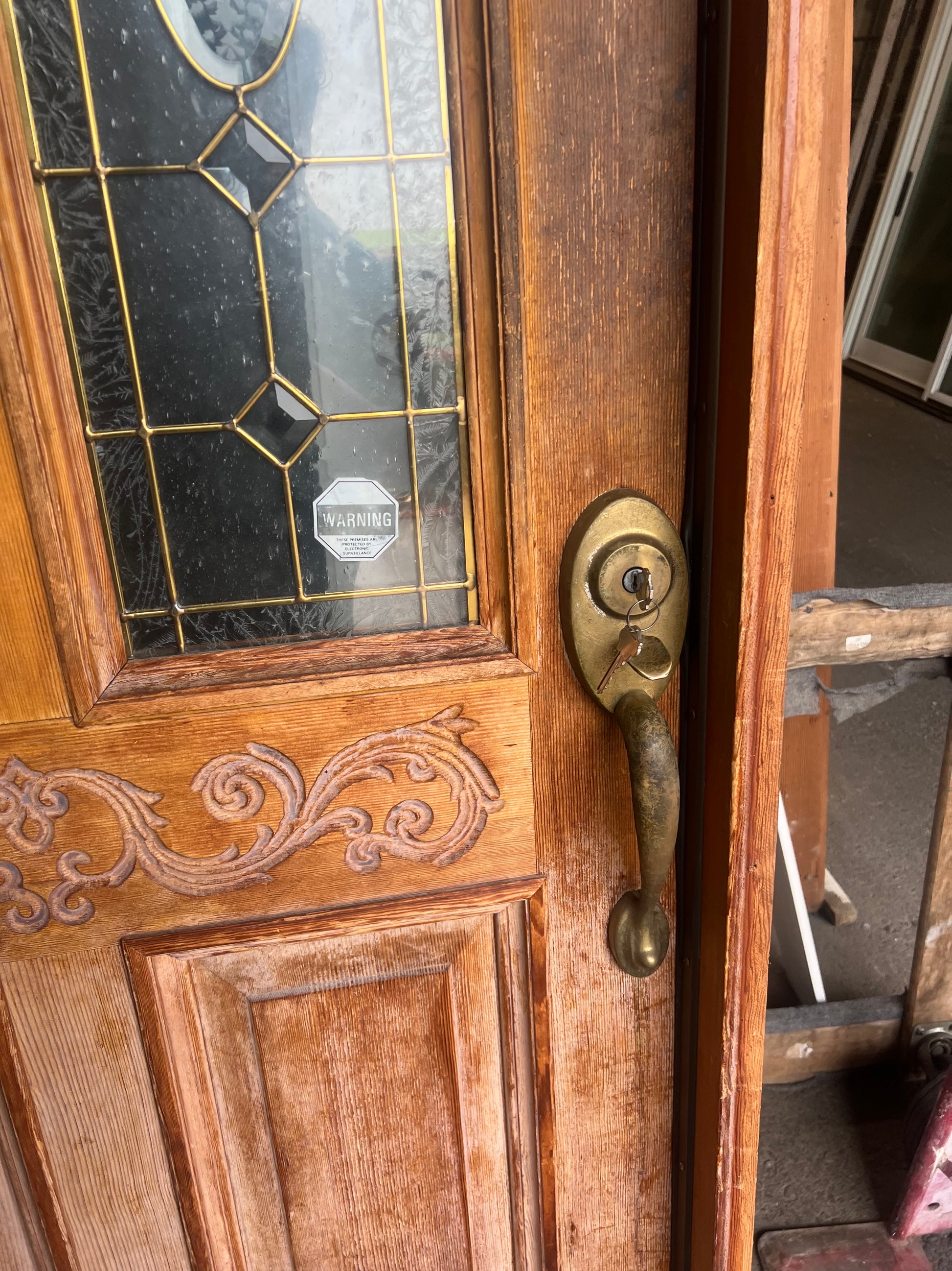 Carved wood exterior door brass handle leaded glass