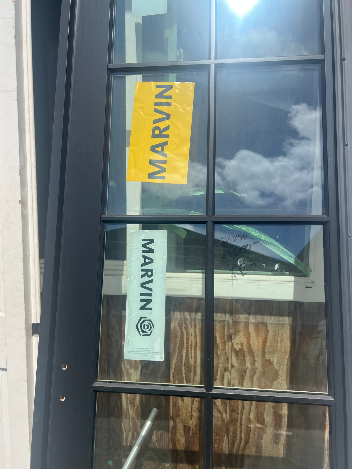 Marvin black door glass panes brand sticker